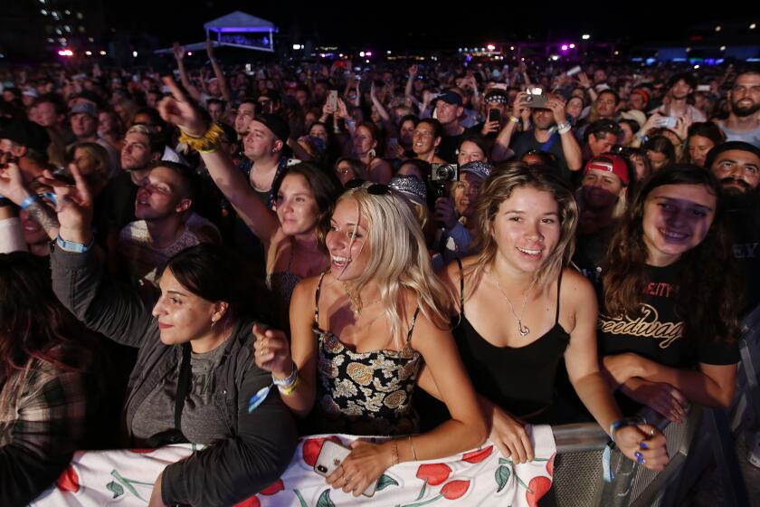 Fans cheer as Kings of Leon performs at the Sunset Cliffs stage at KAABOO Del Mar on Sept. 13, 2019.