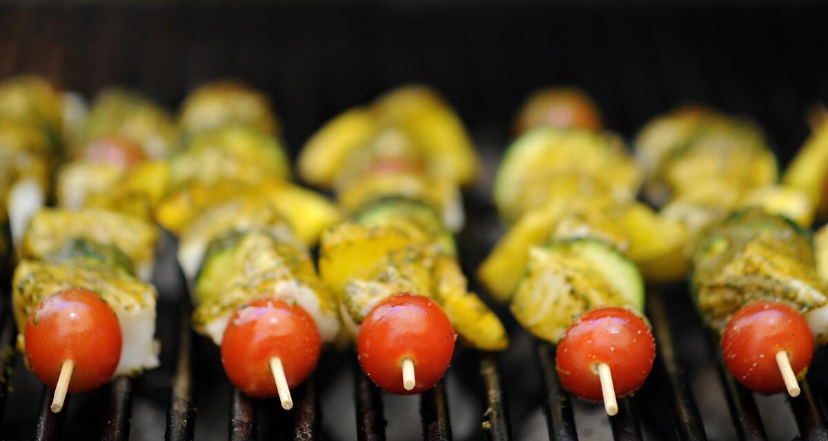 Wine importer Didier Pariente places swordfish kabobs brushed with Chermoula sauce on the grill while cooking a Moroccan lunch with wine pairings at his in-laws' home in Los Angeles on Monday, June 15, 2015.