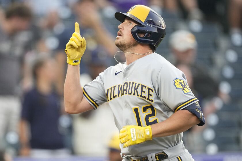 Milwaukee Brewers' Hunter Renfroe gestures as he circles the bases after hitting a two-run home run 