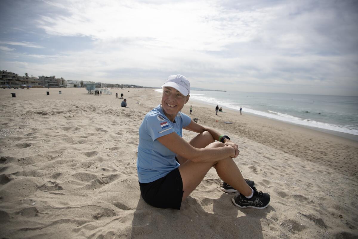 Activist Mina Guli sits on the beach in Venice.
