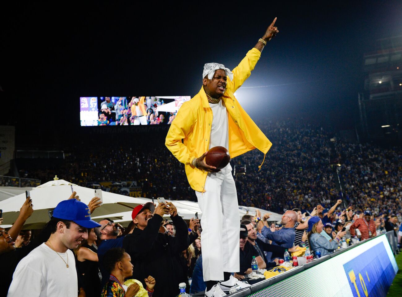 LOS ANGELES, CA - SEPTEMBER 27: Rapper YG stands and cheers with fans at the Los Angeles Rams game against the Minnesota Vikings at Los Angeles Memorial Coliseum on September 27, 2018 in Los Angeles, California. (Photo by Kevork Djansezian/Getty Images) ** OUTS - ELSENT, FPG, CM - OUTS * NM, PH, VA if sourced by CT, LA or MoD **