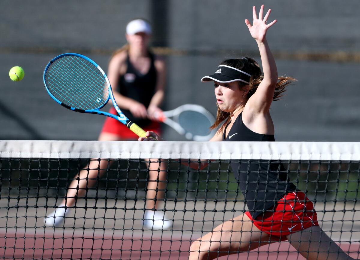 Flintridge Sacred Heart Academy tennis doubles player Hayes Sullivan chases down the ball in home game vs. Century or Torrance in CIF Southern Section Division IV first-round playoff match at Scholl Canyon Golf & Tennis Club in Glendale on Wednesday, Nov. 6, 2019.