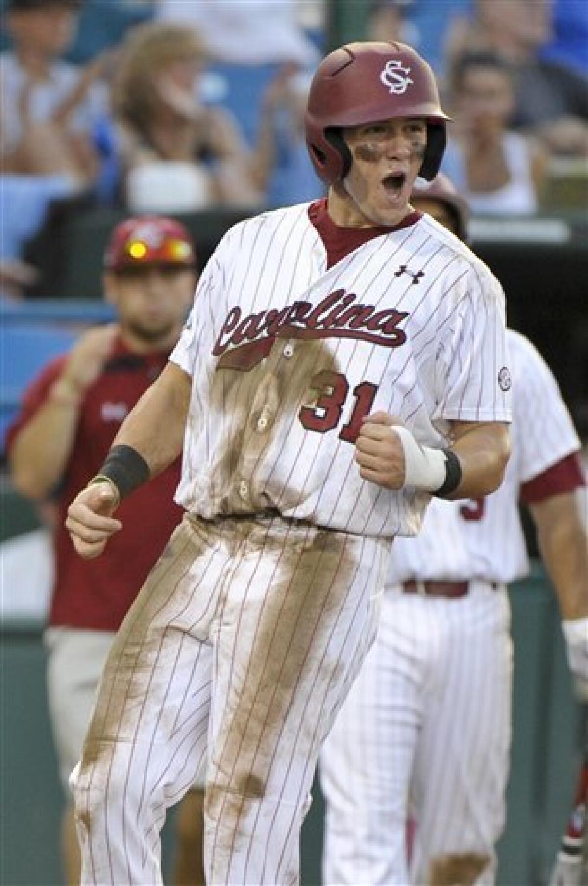 South Carolina's Whit Merrifield beats the throw to Clemson third baseman  John Hinson (4), after Merrifield hit a triple in the fifth inning of an  NCAA College World Series baseball elimination game