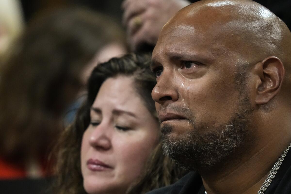 An officer cries during a congressional hearing.