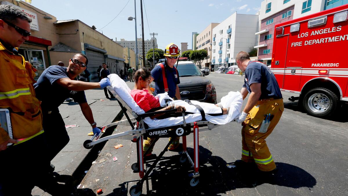 Los Angeles Fire Department personnel provide assistance to a woman believed to be feeling the effects of a synthetic cannabinoid called spice on Monday.