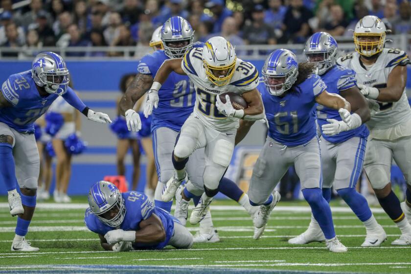 DETROIT, MICHIGAN, SUNDAY, SEPTEMBER 15, 2019 - Chargers running back Austin Ekeler breaks past the line for a long run late in the game against the Lions at Ford Field. (Robert Gauthier/Los Angeles Times)