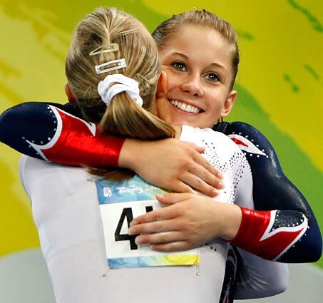 Gold medal winner Shawn Johnson, right, and silver medalist Nastia Liukin embrace moments after the conclusion of the balance beam final.