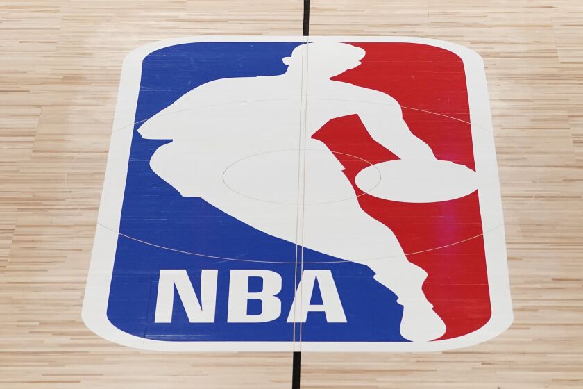 FILE - The NBA logo in shown on a basketball court in Lake Buena Vista, Fla., in this Friday, Aug. 28, 2020.
