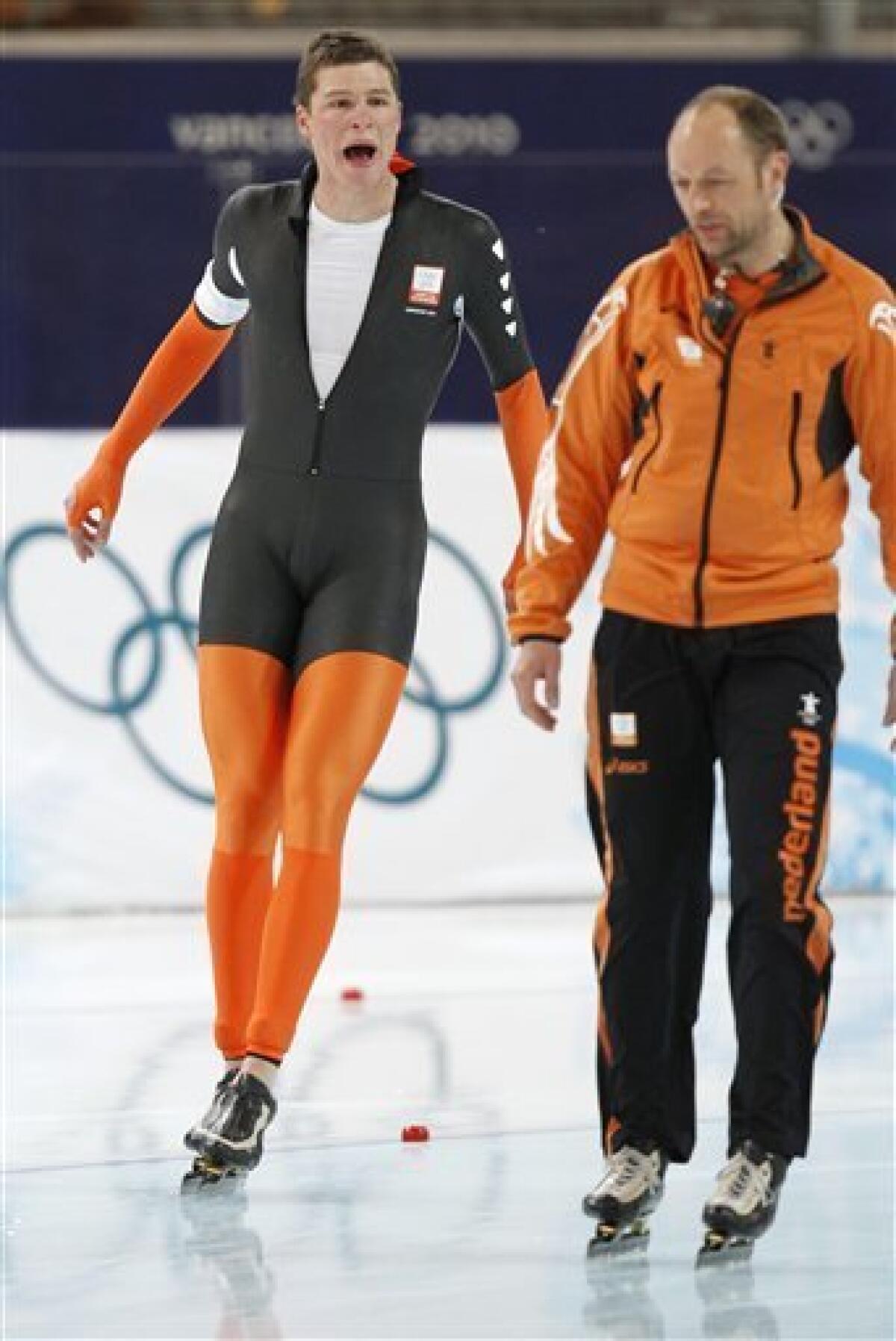 Netherlands's Sven Kramer, left, shouts at his coach Gerard Kemkers, right, after he was disqualified during the men's 10,000 meter speed skating race at the Richmond Olympic Oval at the Vancouver 2010 Olympics in Vancouver, British Columbia, Tuesday, Feb. 23, 2010. Lee Seung-hoon of South Korea won a stunning gold medal in men's 10,000-meter speedskating Tuesday when overwhelming favorite Sven Kramer made an amateurish mistake, failing to switch lanes just past the midway point of the race, and was disqualified. (AP Photo/Kevin Frayer)
