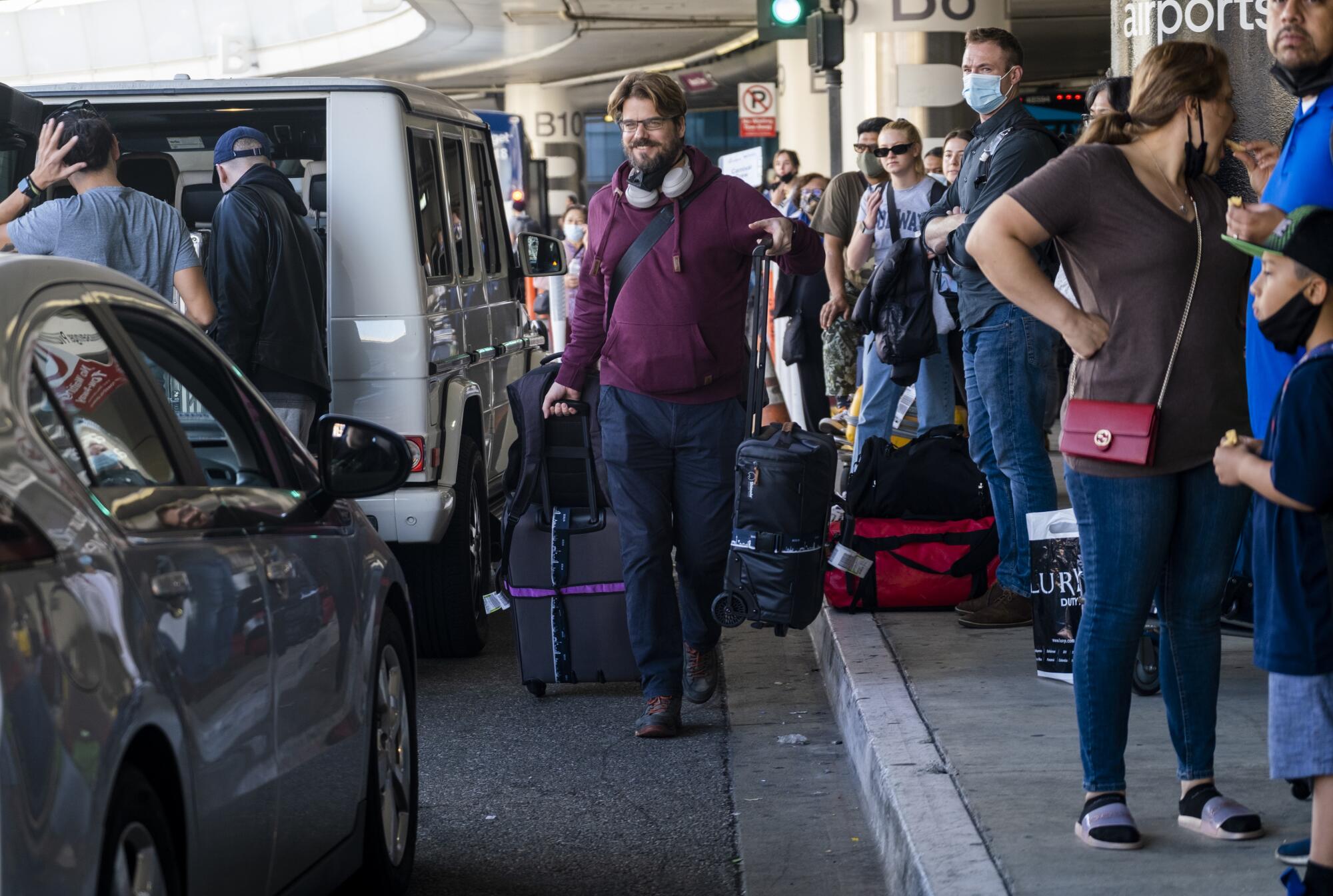 Traveler Daniel Drews rushes to his ride at Los Angeles International Airport 