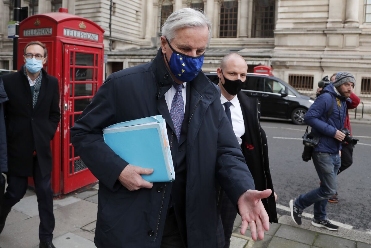 European Commission's Head of Task Force for Relations with the United Kingdom Michel Barnier walks from his hotel to the Conference Centre in London, Wednesday, Nov. 11, 2020. With less than two months to go before the U.K. exits the EU's economic orbit, trade deal talks resume in London. (AP Photo/Frank Augstein)