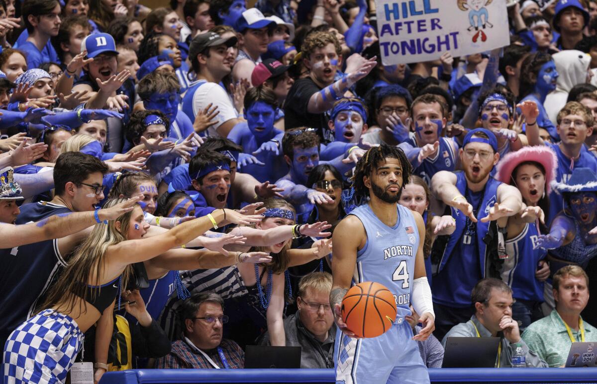 North Carolina's RJ Davis in-bounds the ball in front of the Duke student section during a game on March 9.