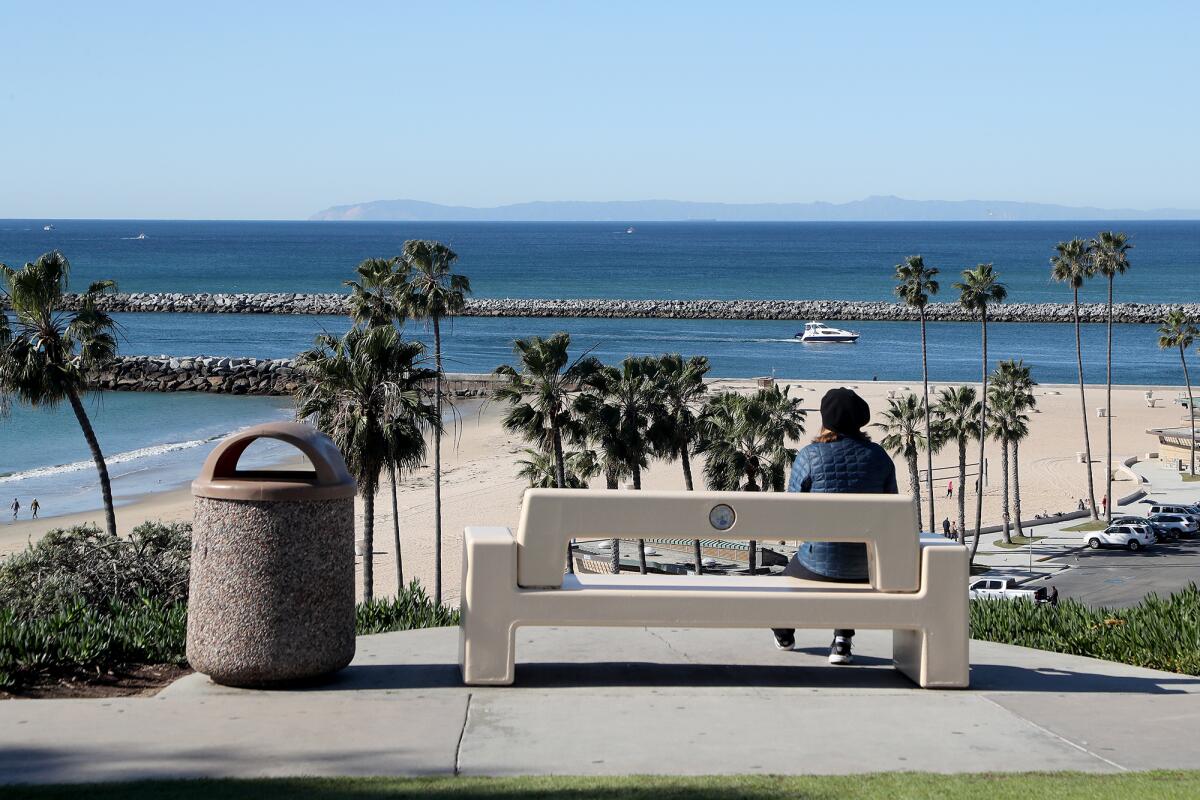 A woman looks out over Corona Del Mar State Beach Park on Wednesday morning.