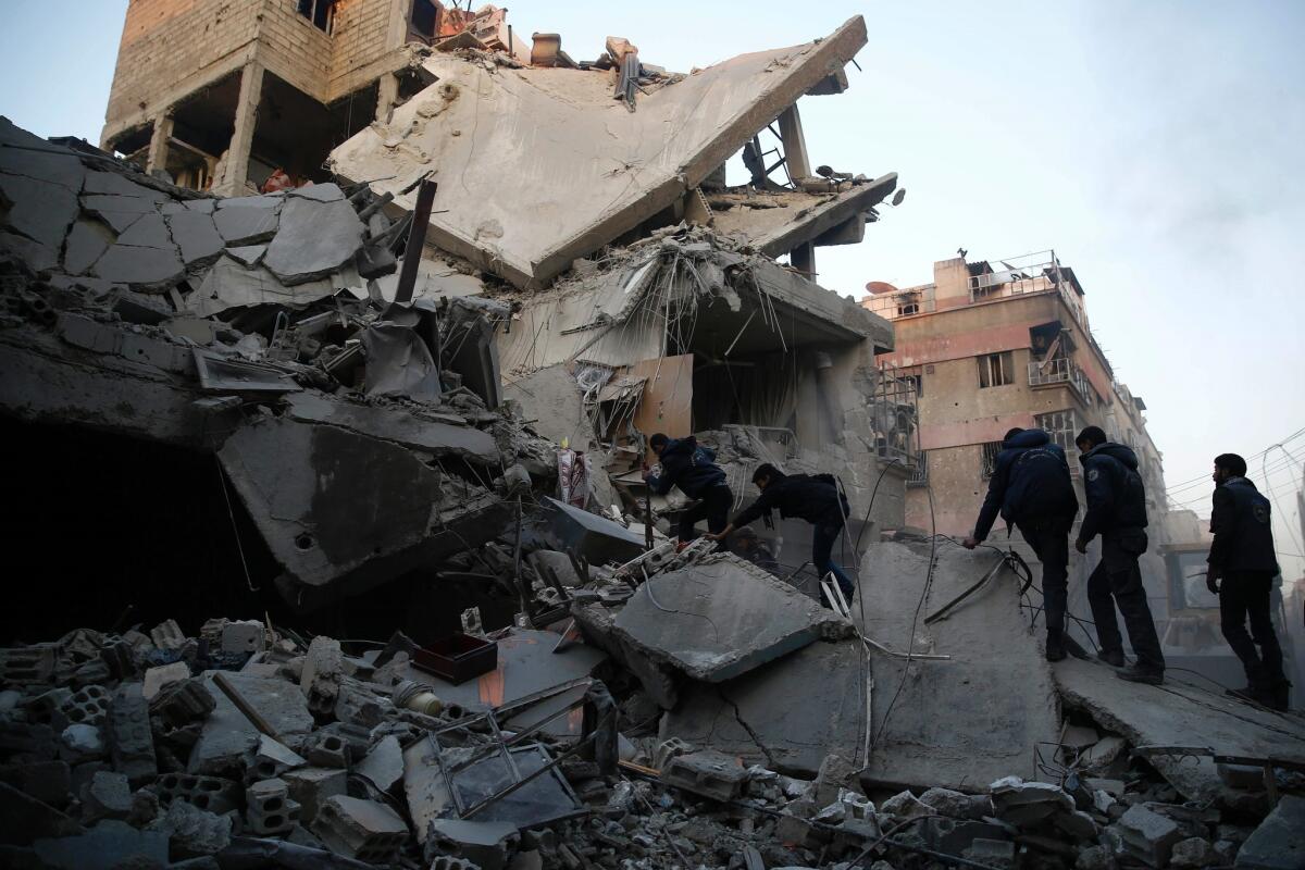 Syrians and civil defense workers search for victims after Syrian government airstrikes on Douma, a rebel stronghold east of Damascus, the capital, on Jan. 10.