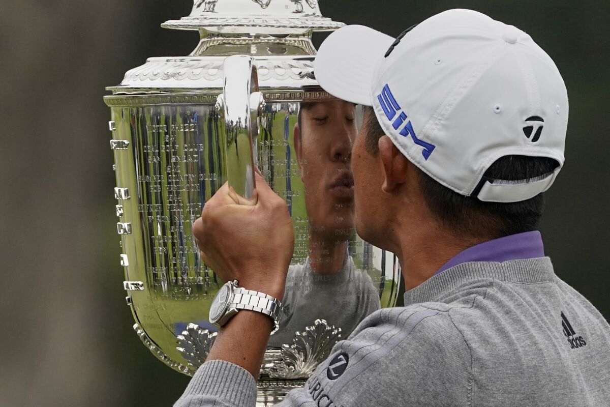 Collin Morikawa kisses the Wanamaker Trophy after winning the PGA Championship.