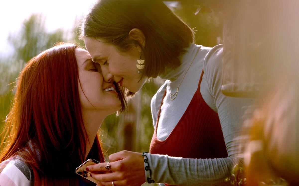 On the Syfy show "Wynonna Earp," Waverly Earp leans in for a kiss with town sheriff Nicole Haught.