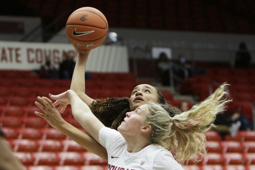 Stanford guard Haley Jones, back, shoots over Washington State guard Grace Sarver during the second half of an NCAA college basketball game, Sunday, Jan. 2, 2022, in Pullman, Wash. Stanford won 82-44. (AP Photo/Young Kwak)