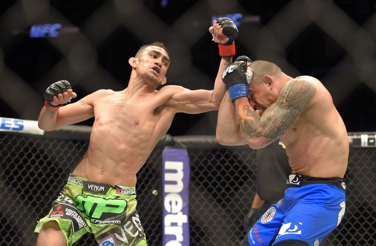 Tony Ferguson, left, throws a punch at Gleison Tibau on his way to victory by first-round submission during UFC 184 at Staples Center.