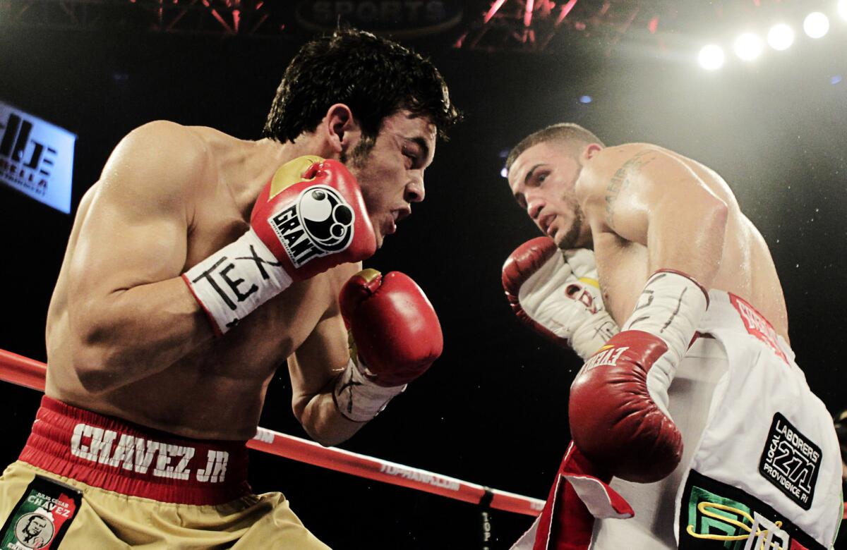 Julio Cesar Chavez Jr. and Peter Manfredo Jr., right, exchange punches during a fight Nov. 19, 2011, in Houston.
