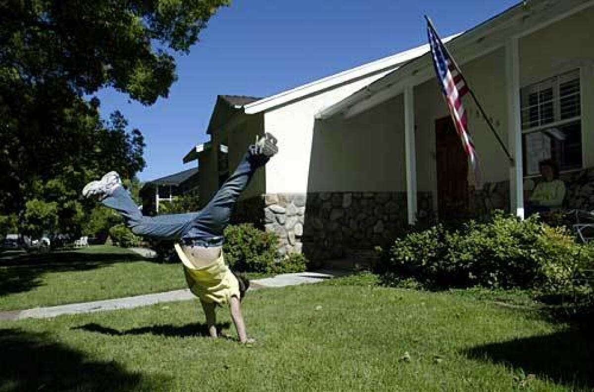 Megan Campbell, 6, plays on her lawn in Sherman Oaks, where traditional and tract houses predominate.