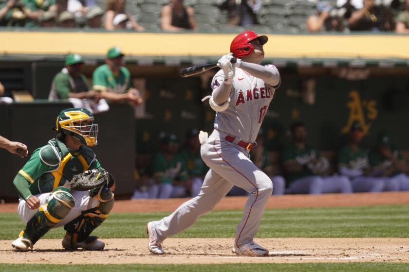 Los Angeles Angels' Shohei Ohtani hits a home run in the second inning of a baseball game.