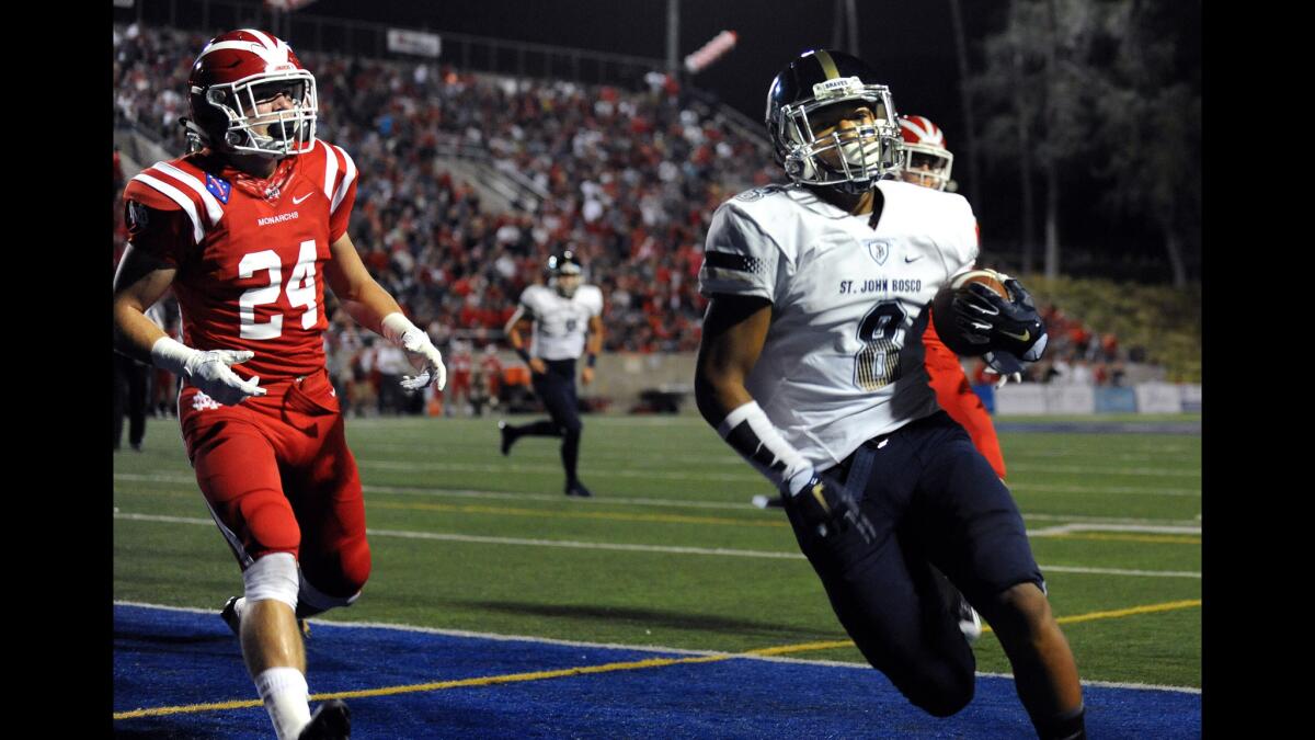 St. John Bosco's Cross Poyer beats Mater Dei's Chase Ault to score the first points of the game in the first quarter Friday night.