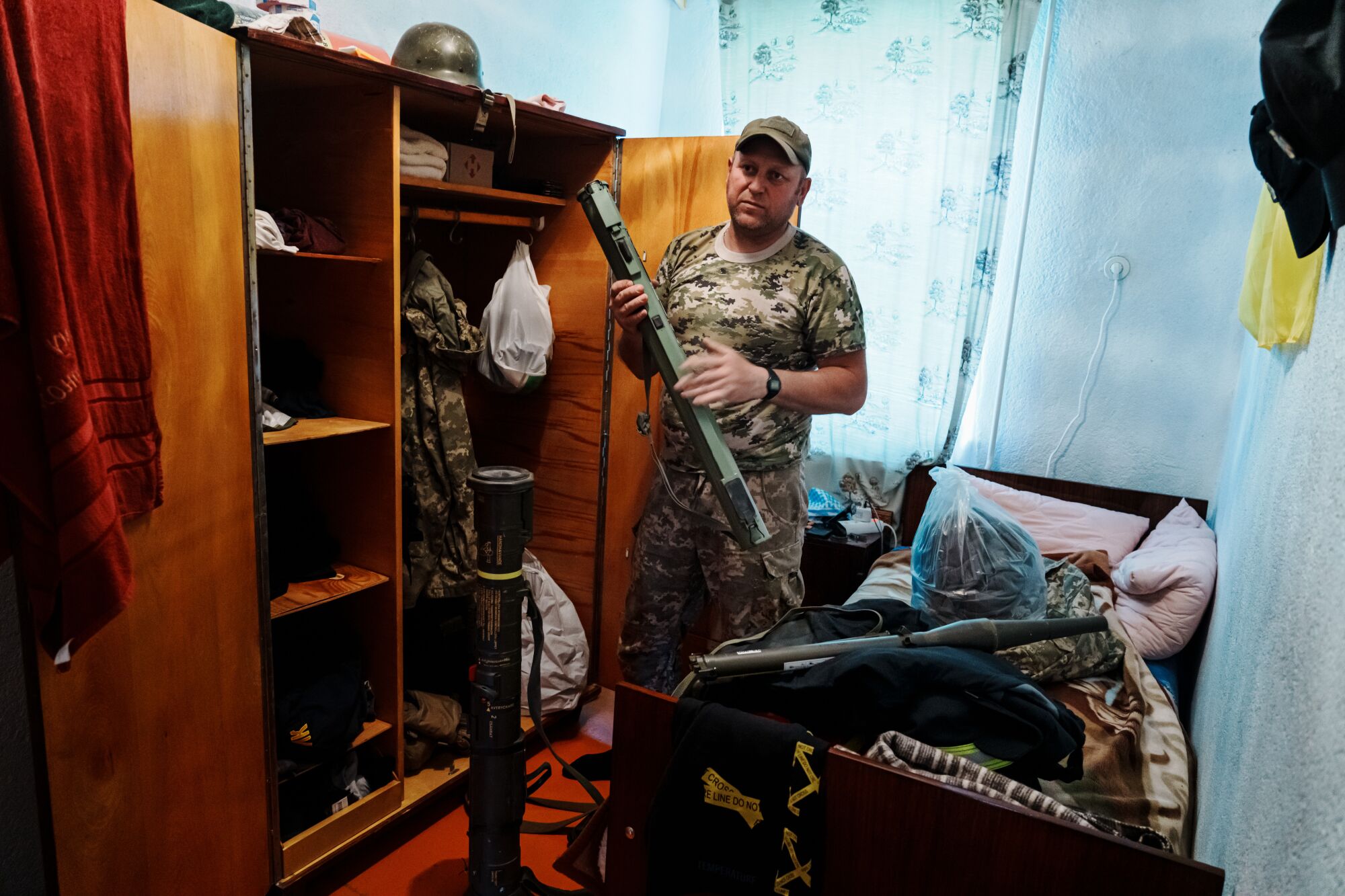 A year of war: Los Angeles Times photographers document the battle in Ukraine 8 A man stands near an open cupboard