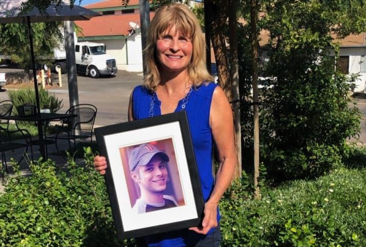 Lorraine Kerz holds a photo of her late son 