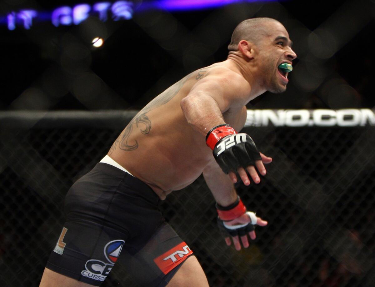 Renan Barao celebrates following his victory by technical knockout over Urijah Faber for the bantamweight title at UFC 169 in Newark, N.J.