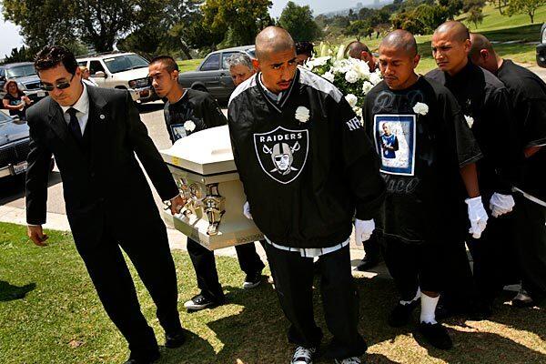 Family members, friends and gang members of 38th Street bury one of their own at a cemetery in west Los Angeles. "Flaco" Moreno was gunned down on a corner in South L.A. Members readied themselves for retaliatory strikes against the suspected hit squad, another Latino gang.