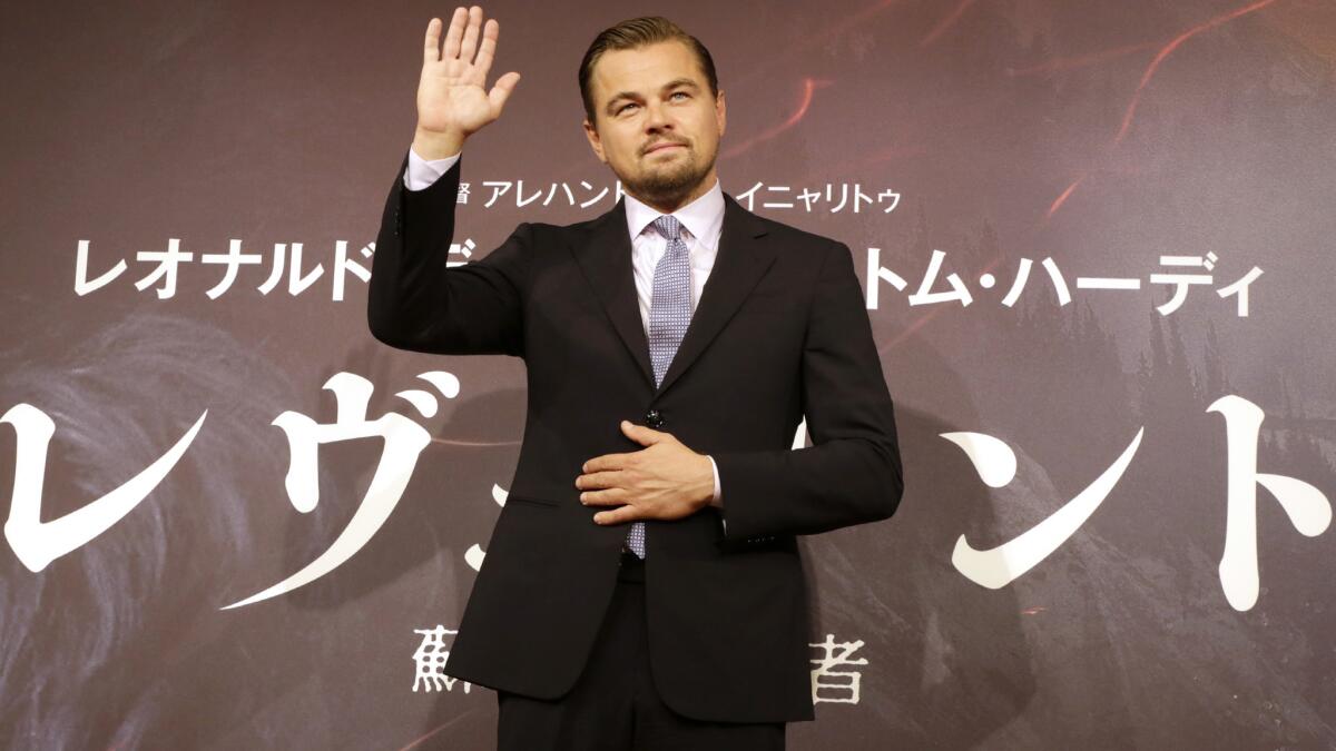 Actor Leonardo DiCaprio waves during a photo session for the movie “The Revenant” in Tokyo on March 23.