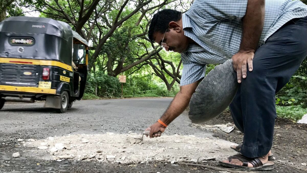 His son died in a road accident, so India's 'pothole dada' fills his  family's sorrow with stone and gravel - Los Angeles Times
