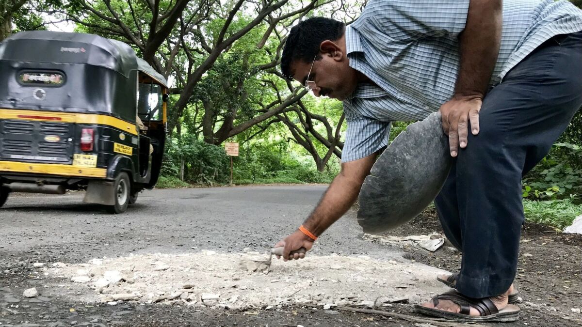 His son died in a road accident, so India's 'pothole dada' fills his family's sorrow with stone and gravel - Los Angeles Times