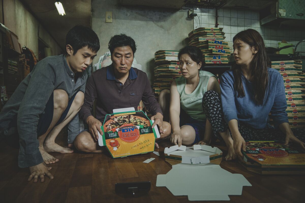 The Kim family folds pizza boxes in Bong Joon Ho's "Parasite."