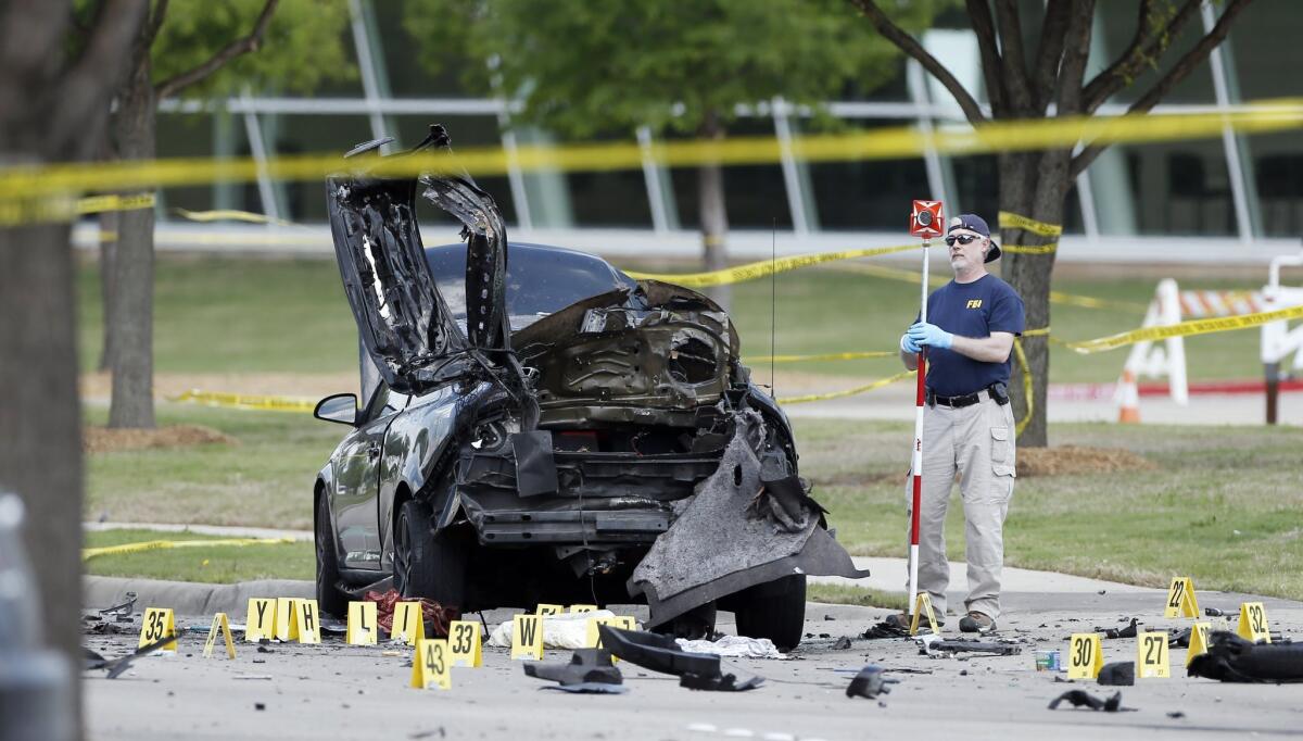 FBI crime scene investigators document evidence outside the Curtis Culwell Center on Monday in Garland, Texas. Two men on Sunday night opened fire with assault weapons outside the building, the site of a contest for Muslim Prophet Muhammed cartoons.