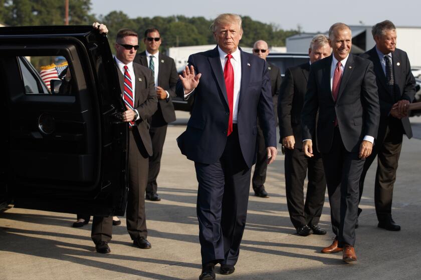 Sen. Thom Tillis, R-N.C., right, walks with President Donald Trump as they arrive on Air Force One at Pitt Greenville Airport, in Greenville, N.C., Wednesday, July 17, 2019. (AP Photo/Carolyn Kaster)