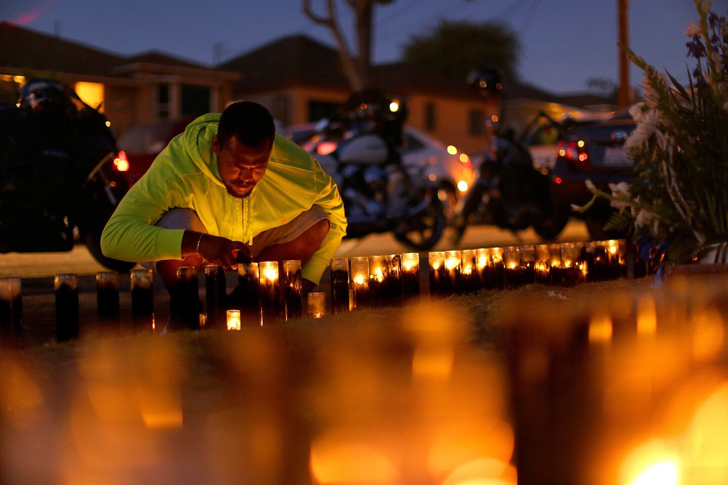 Carl Winzer lights candles at the scene where 18-year-old Carnell Snell Jr. was fatally shot by Los Angeles police officers.