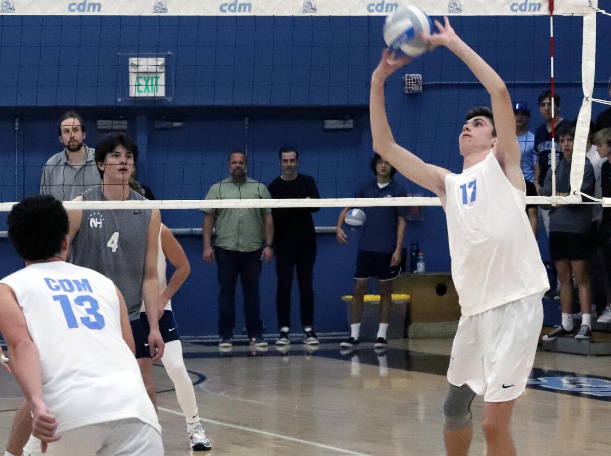 Corona del Mar's Ryan Grant (17) sets up an opportunity for teammate Everett Welton (13) during Friday's match.