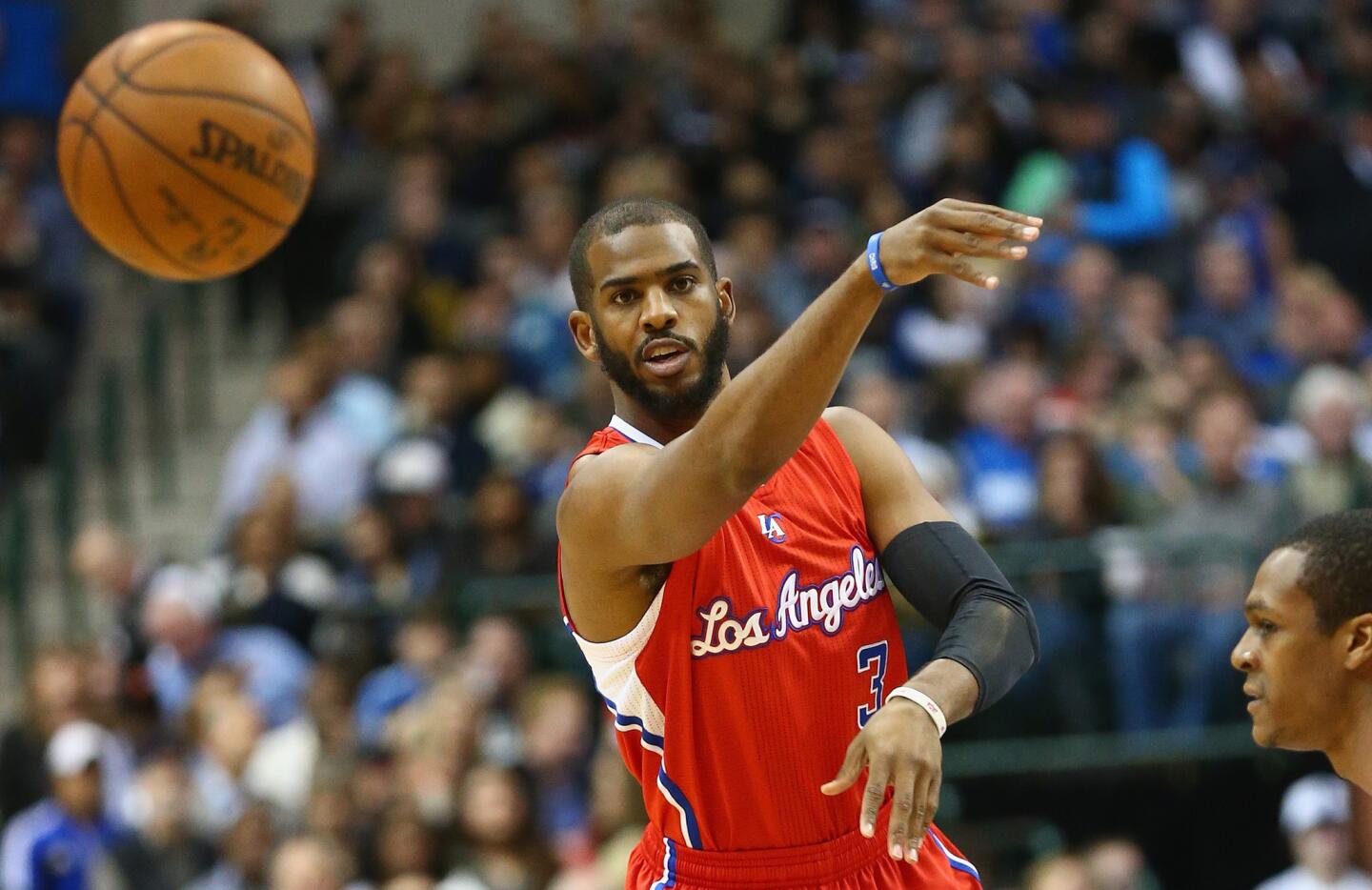 Clippers point guard Chris Paul flips a pass to a teammate in the first half Friday night at Dallas.