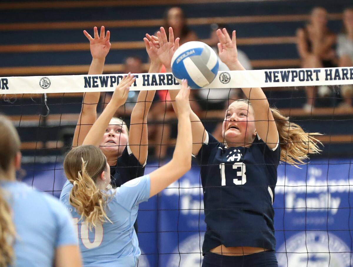 Newport Harbor's Sadie Henderson (13) jousts against Corona del Mar's Molly Machoskie.