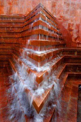 Made of hand-chiseled cantera stone, the fountain has been re-piped and equipped to run at variable rates of flow. Though the design is described as Mayan-inspired and Barragán rarely used such fussy vernacular, the Los Angeles Cultural Heritage Commission declared it a signature project of Barragán, an architect of international fame and an architect of great importance to contemporary Mexican culture.