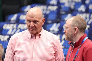 Clippers owner Steve Ballmer, left, talks to president of basketball operations Lawrence Frank before a playoff game.