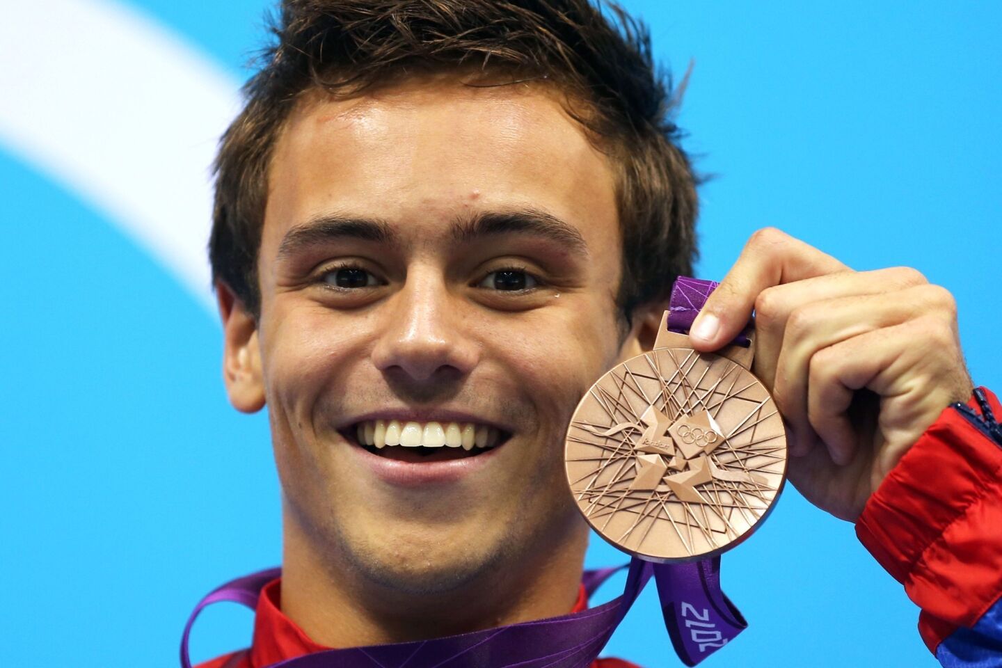 Nineteen-year-old British Olympic diving bronze medalist Tom Daley revealed through a YouTube video that he's in a relationship with a man and has been since spring.