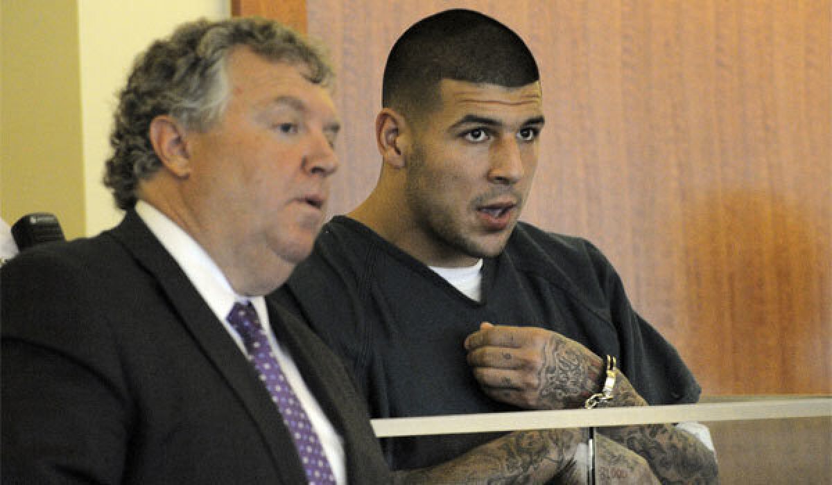 Former New England Patriots tight end Aaron Hernandez, right, stands with attorney Michael Fee during a bail hearing in Fall River Superior Court on Thursday.
