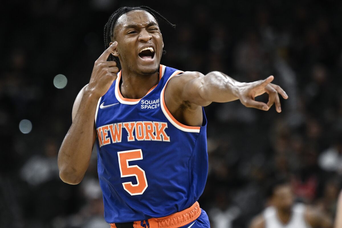 New York Knicks' Immanuel Quickley celebrates a basket during the second half of the team's NBA basketball game against the San Antonio Spurs, Tuesday, Dec. 7, 2021, in San Antonio. The Knicks won 121-109. (AP Photo/Darren Abate)