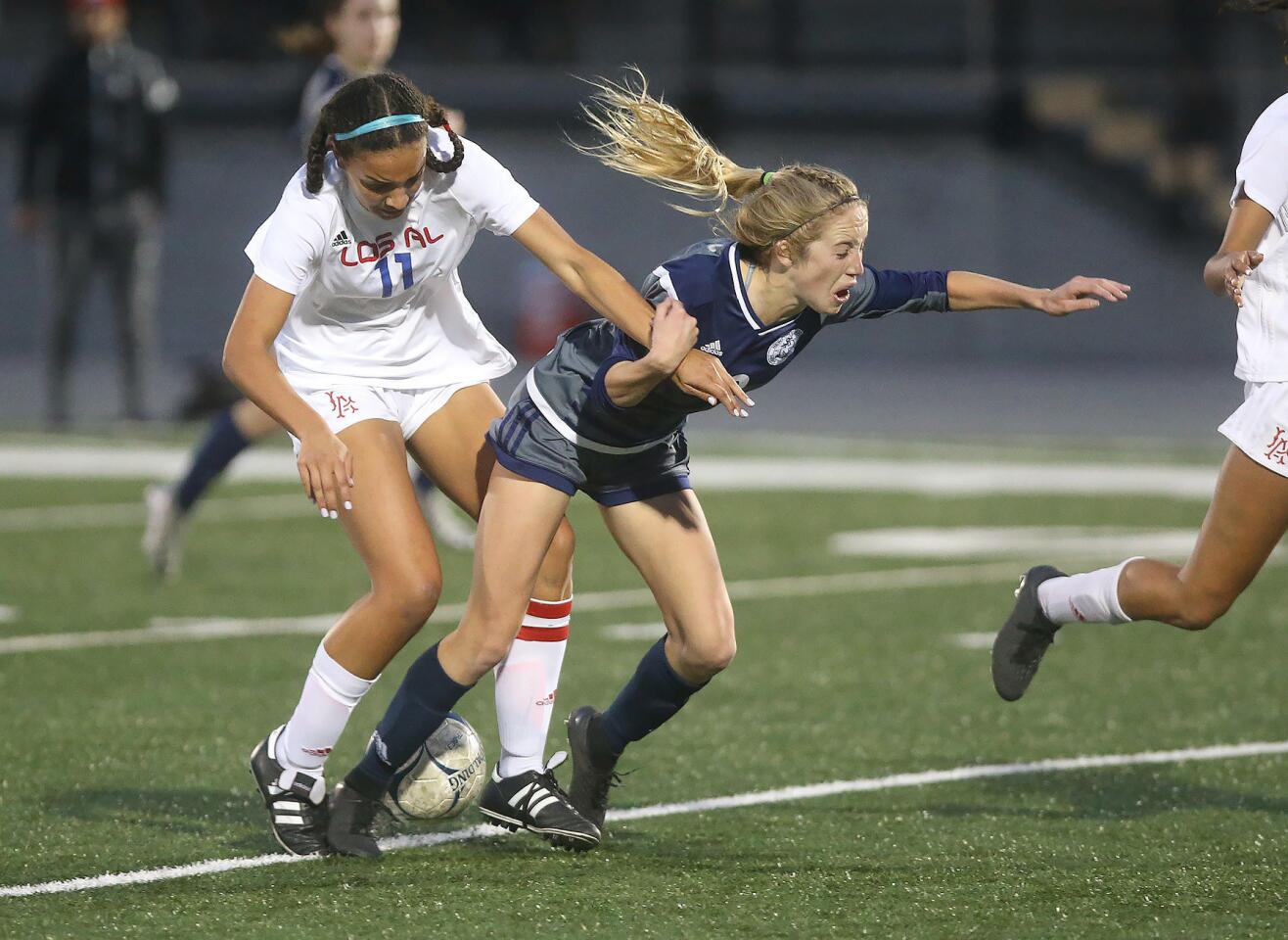 Reese Bodas of Newport Harbor High is pushed off the ball by Los Alamitos' Jayden Newkirk in the quarterfinals of the CIF Southern Section Division 1 playoffs on Tuesday.