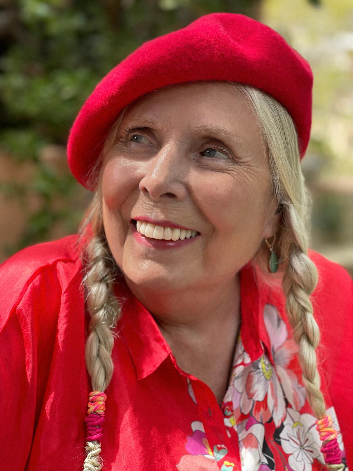 A woman in a red beret and braids