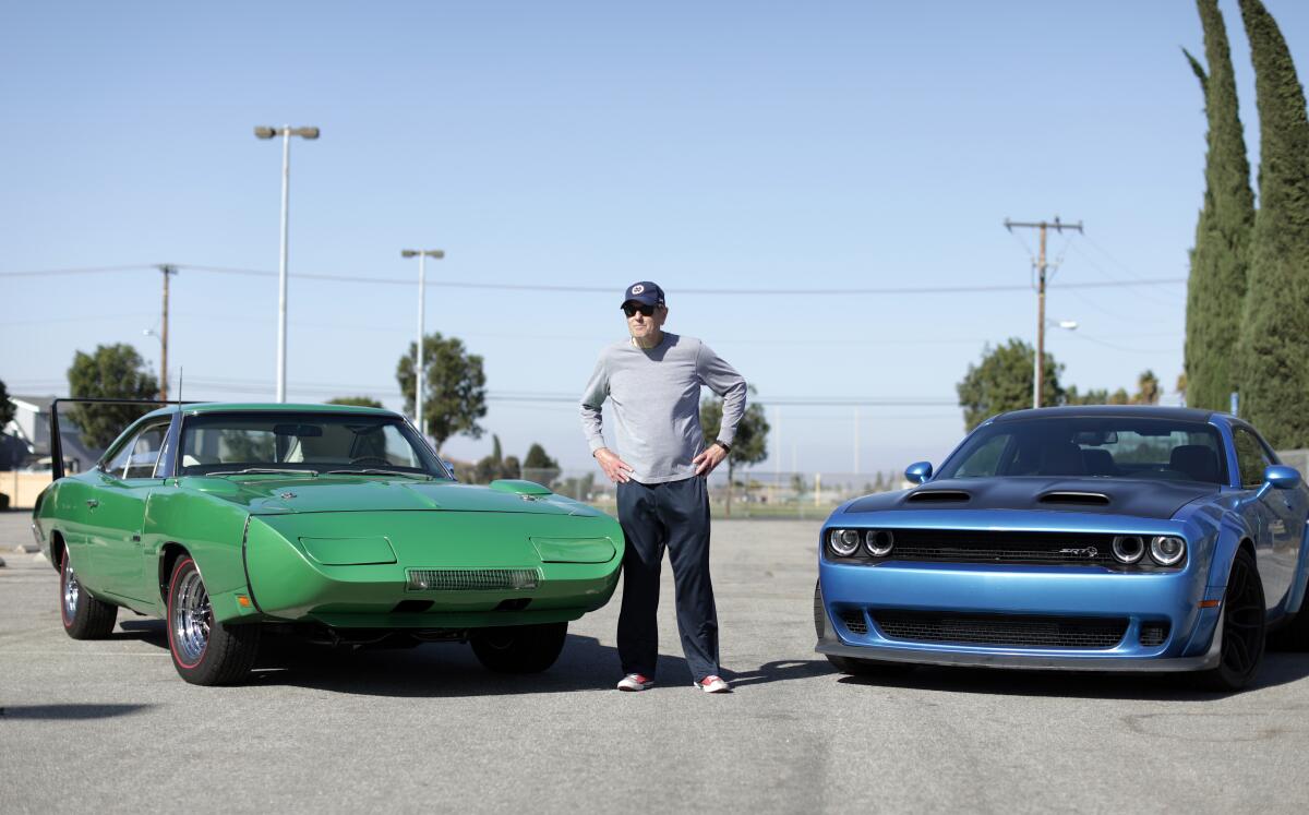 Car collector Greg Joseph is the owner of a 1969 Dodge Charger Daytona Hemi, left. The Dodge Challenger Hellcat Redeye, right, has taken up the mantle as the brand's fastest ride these days.