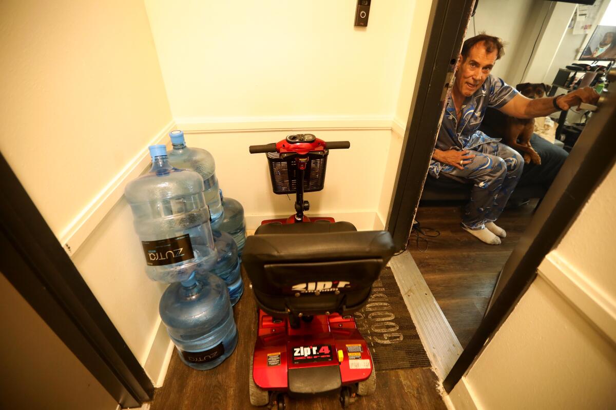 Michael Konlon, 57, looks out from his room into the hallway at the Baltimore Hotel.