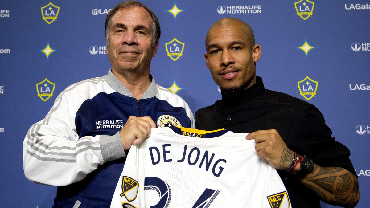 Galaxy Coach and GM Bruce Arena, left, introduces midfielder Nigel de Jong to reporters on Feb. 16.